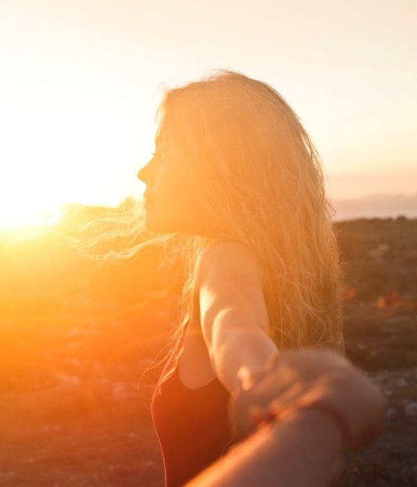 Silhouette of a person in a serene pose at sunset.